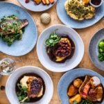 Various festive dishes on a wooden table