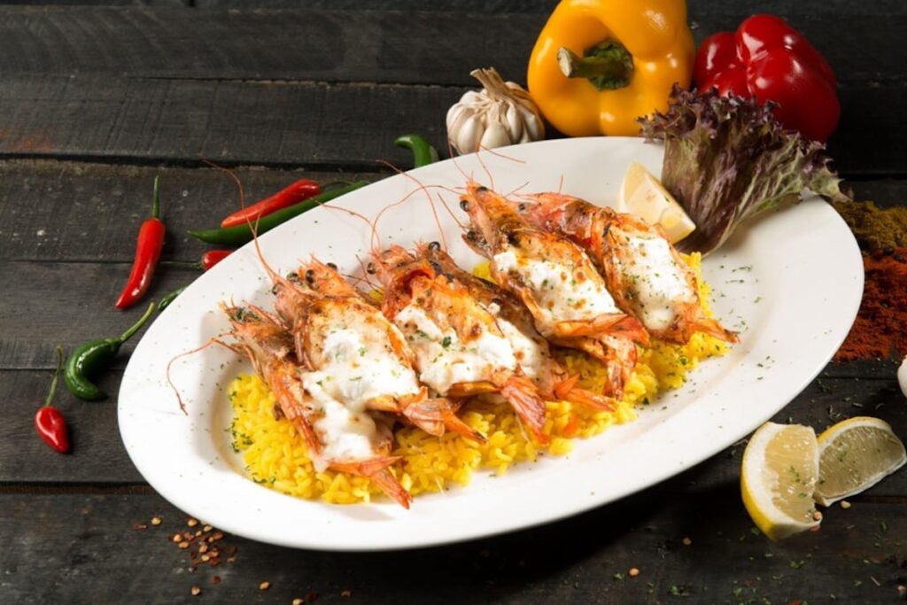 Prawns in white sauce on bed of yellow rice