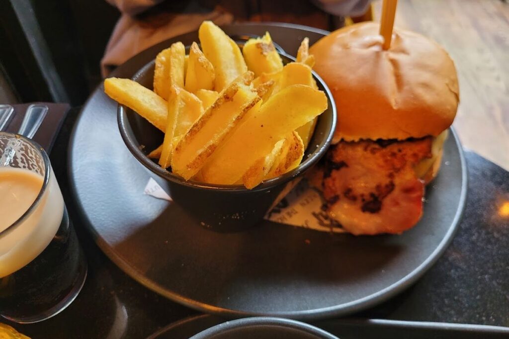 Burger and chips on black plate