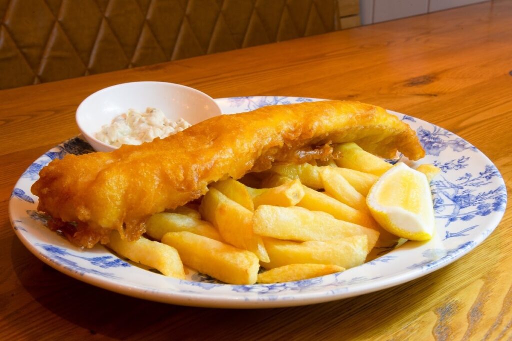 Fish and chips with lemon wedge and tartare sauce