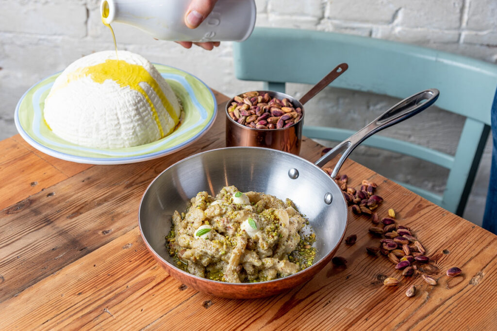 Pasta in a saucepan with Italian cheese and olive oil